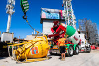 Piave cement truck pouring cement into funnel attached to crane