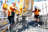 Piave cement workers pouring cement into steel scaffolding