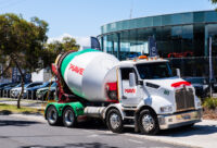 Piave cement truck in front of car dealership