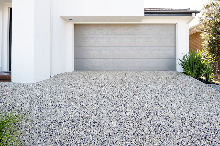 Modern home with a decorative cement driveway